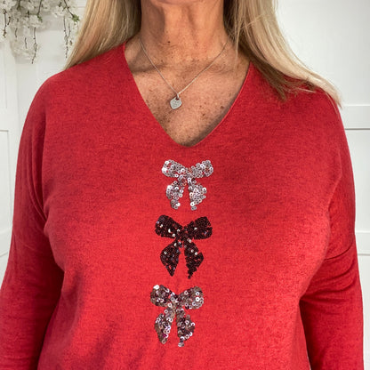 Ellie: Sequin V neck bow top. One size: 12-18