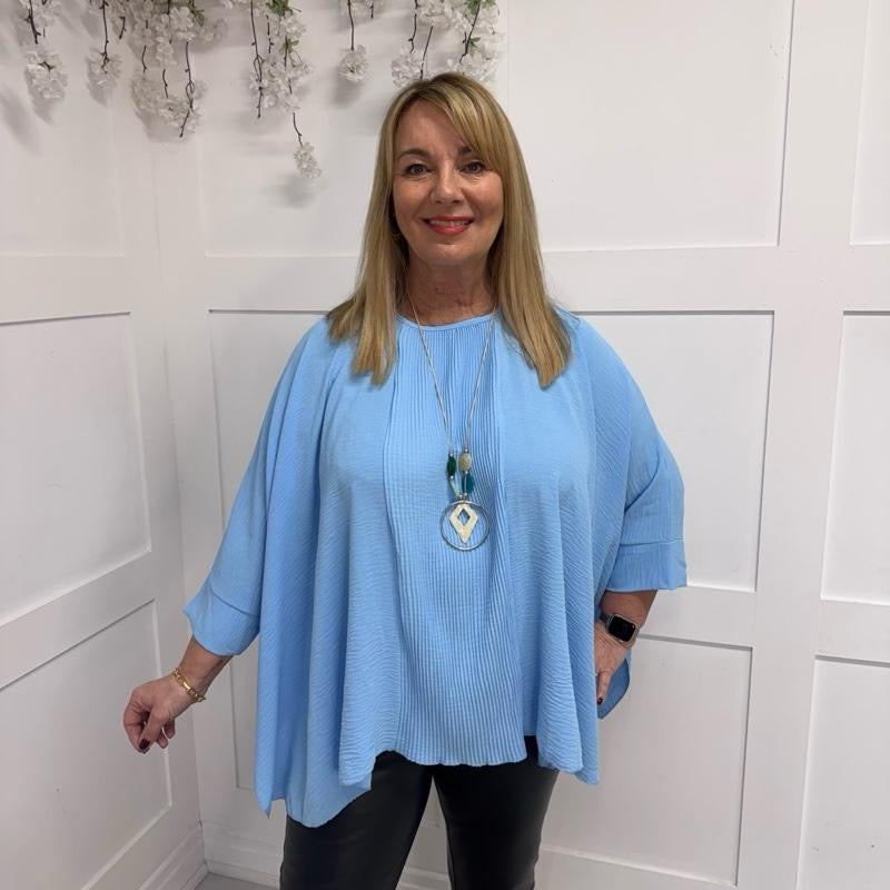 Becca: Oversized blue pleated batwing blouse with necklace. Free size