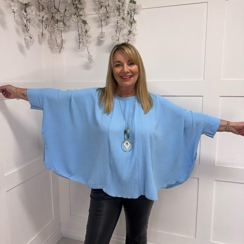 Becca: Oversized blue pleated batwing blouse with necklace. Free size