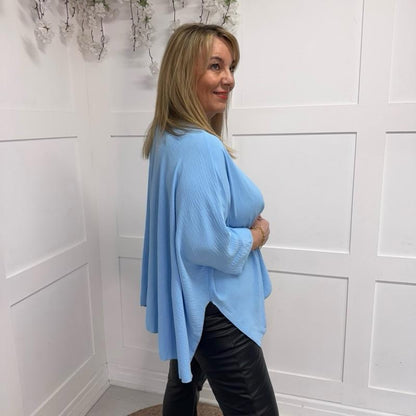 Becca: Oversized blue pleated batwing blouse with necklace. Free size